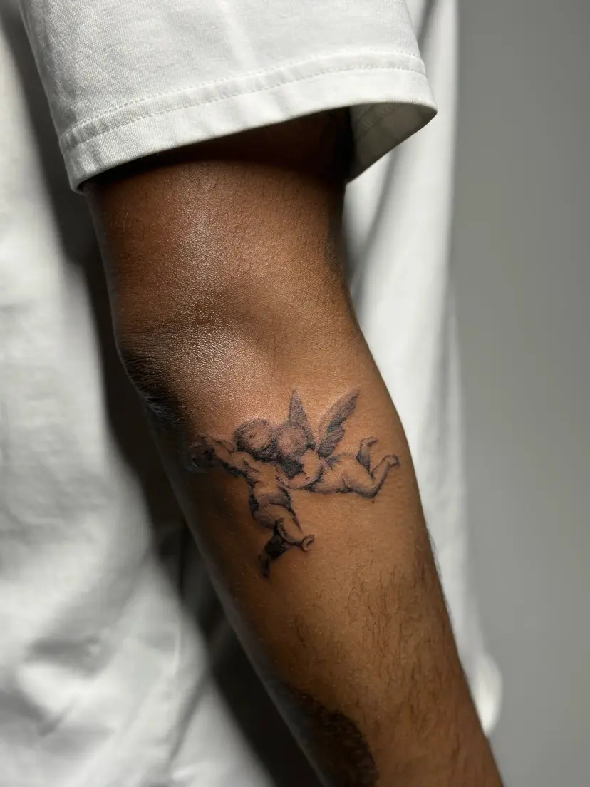 Cherub tattoo on a forearm