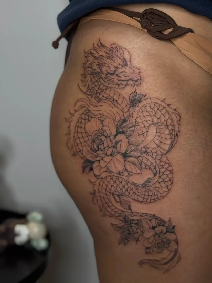 Dragon and peony tattoo on the hip and thigh